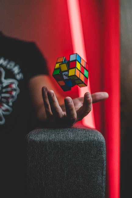 Rubik's Cube levitating over a hand with vibrant backdrop, creating a sense of whimsy and intrigue.