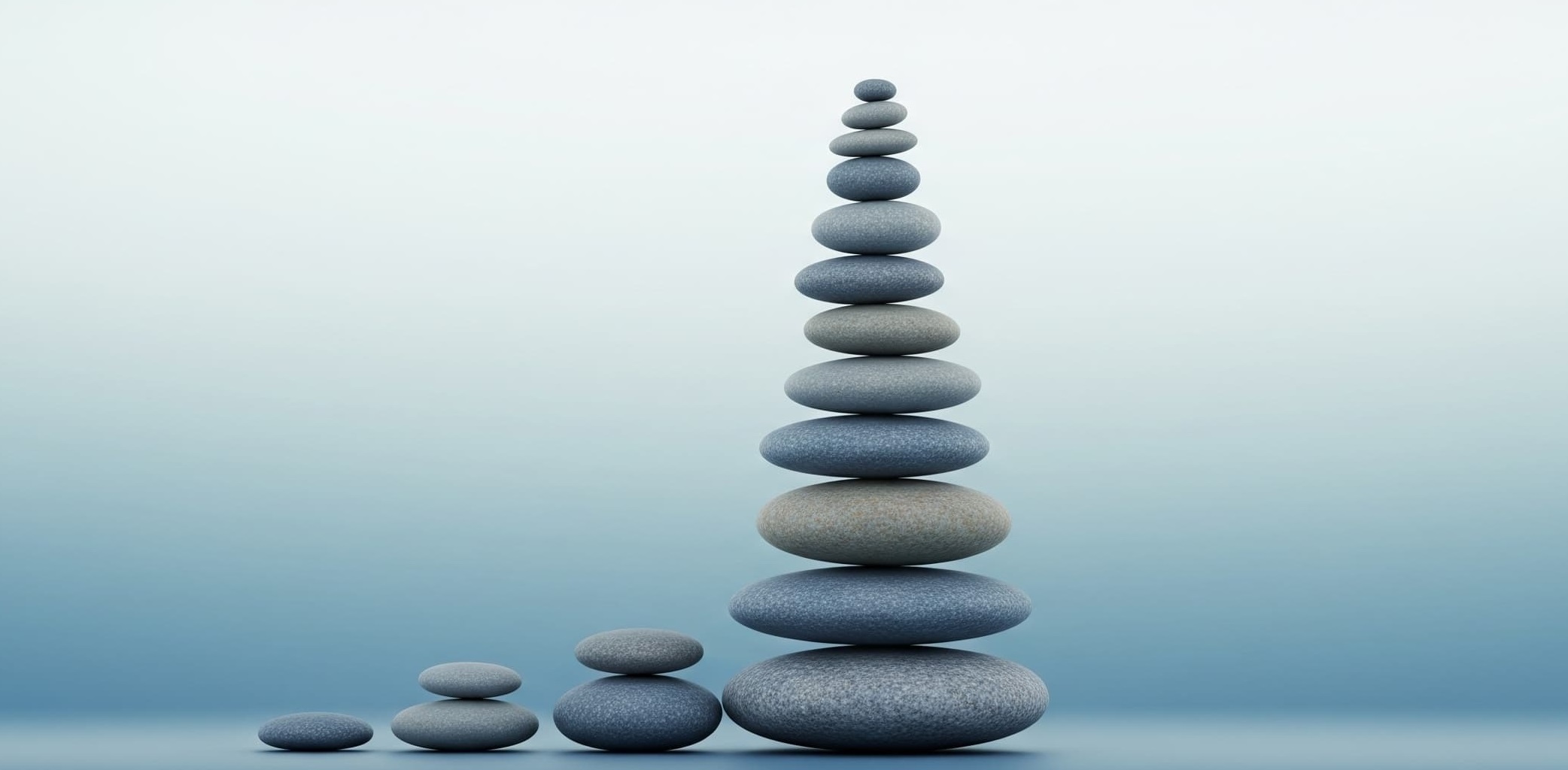 Stones stacked on top of each other represent the cumulative and compound effect.