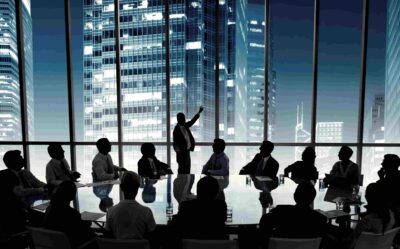 Businessman leading a meeting while colleagues attentively listen and take notes in a modern office setting. Achieve Leadership Without Dominance