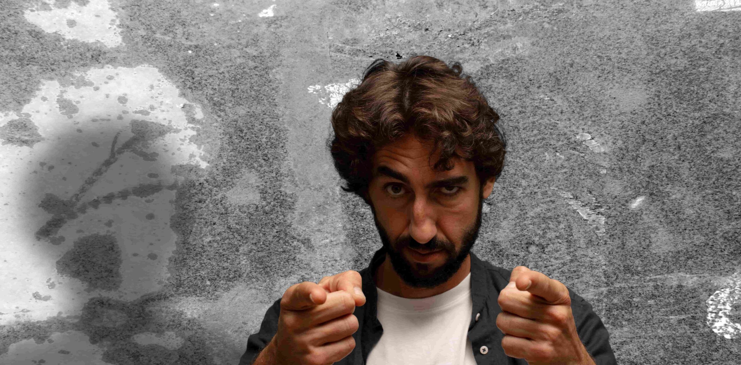 A person or man who looks down on people and belittles them. He points both fingers at the camera.Arrogance